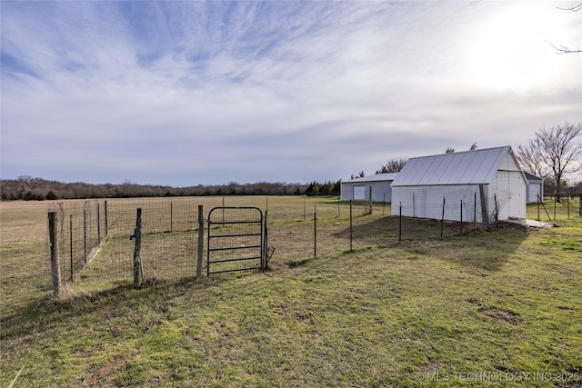 1522 Burney Cemetary, Calera, OK 74730 - view of yard featuring a gate, an outdoor structure, fence, a detached garage, and a rural view