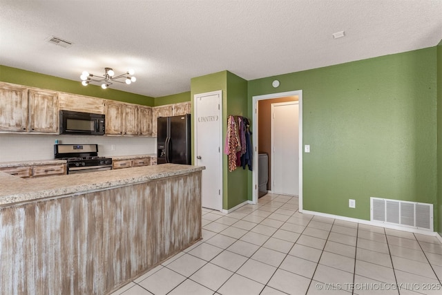 kitchen featuring visible vents, black appliances, light tile patterned flooring, and light countertops