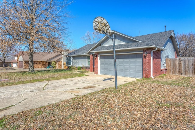 ranch-style house with brick siding, an attached garage, a shingled roof, fence, and driveway