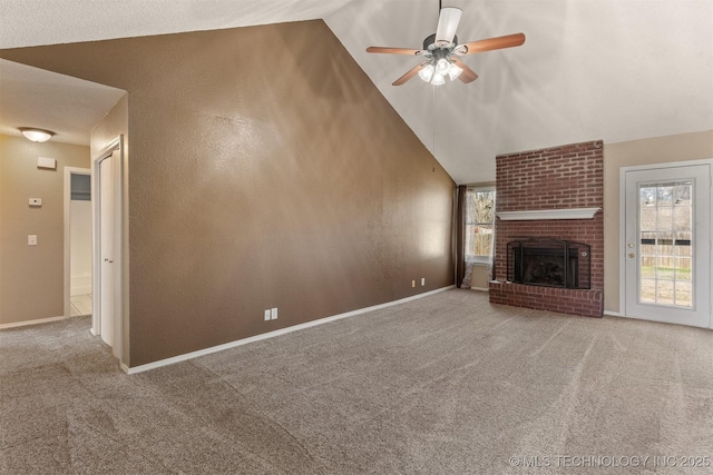 unfurnished living room featuring plenty of natural light, a brick fireplace, baseboards, and carpet