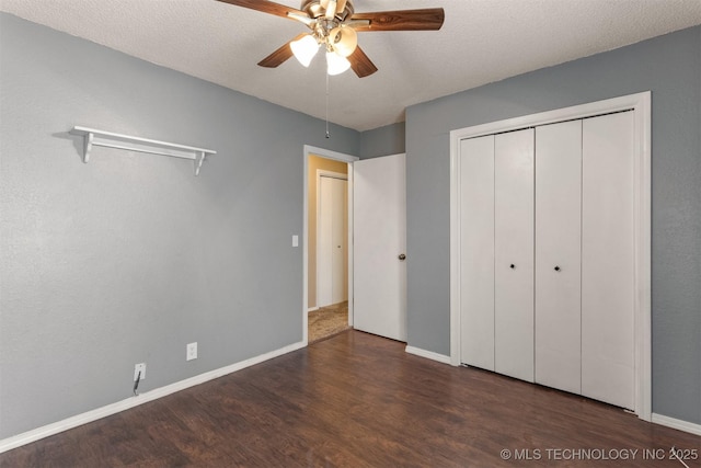 unfurnished bedroom with wood finished floors, baseboards, and a textured ceiling