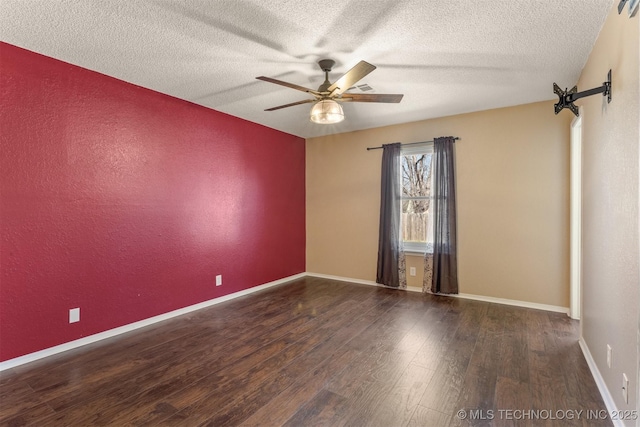 spare room featuring a ceiling fan, a textured ceiling, wood finished floors, baseboards, and a textured wall