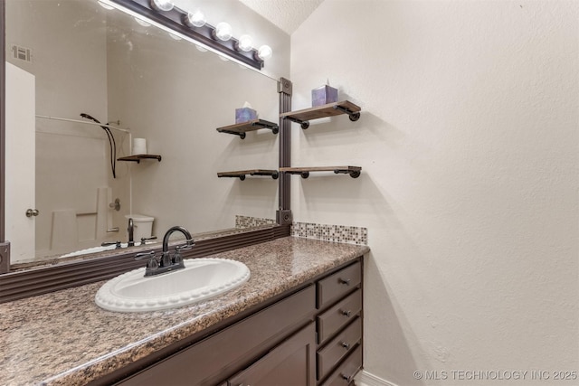 bathroom with visible vents, toilet, and vanity