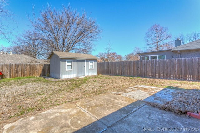 exterior space featuring a storage shed, an outbuilding, a patio area, and a fenced backyard