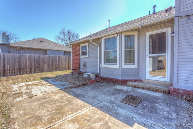 rear view of property with a patio and fence