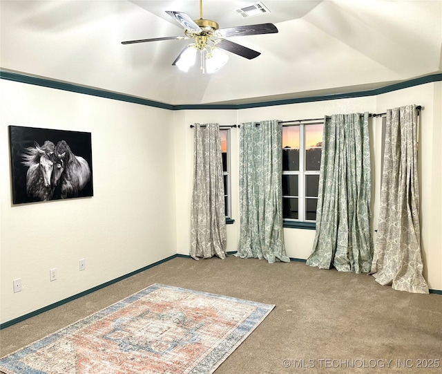 empty room with visible vents, baseboards, a ceiling fan, and carpet flooring