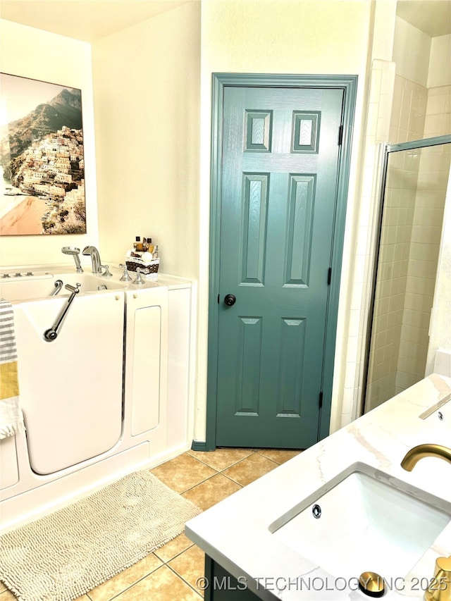 full bathroom featuring vanity, tile patterned floors, a bath, and a tile shower