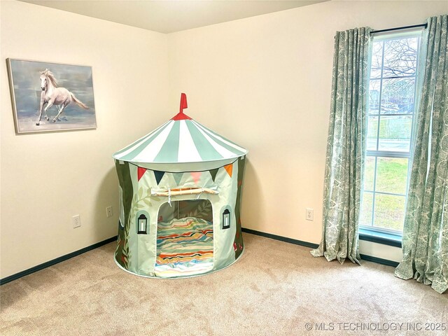 game room featuring plenty of natural light, baseboards, and carpet flooring