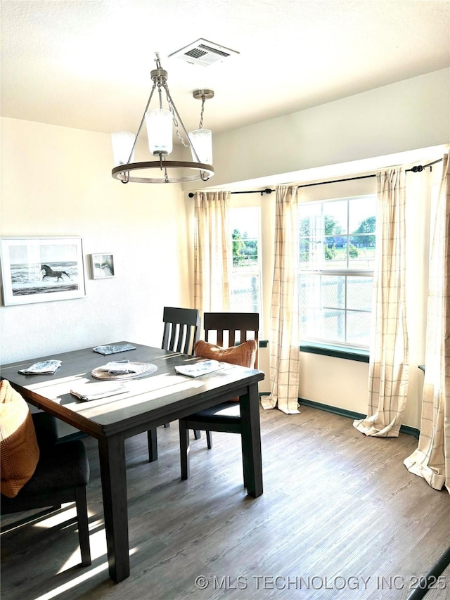 dining space featuring wood finished floors and visible vents