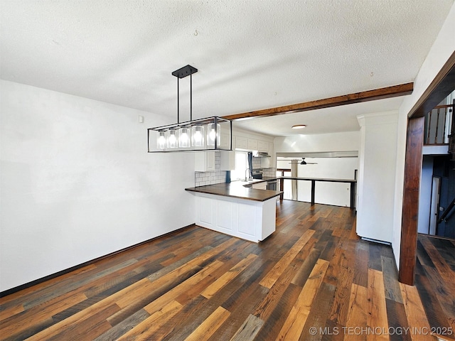 kitchen featuring backsplash, dark wood-type flooring, beamed ceiling, a peninsula, and white cabinets