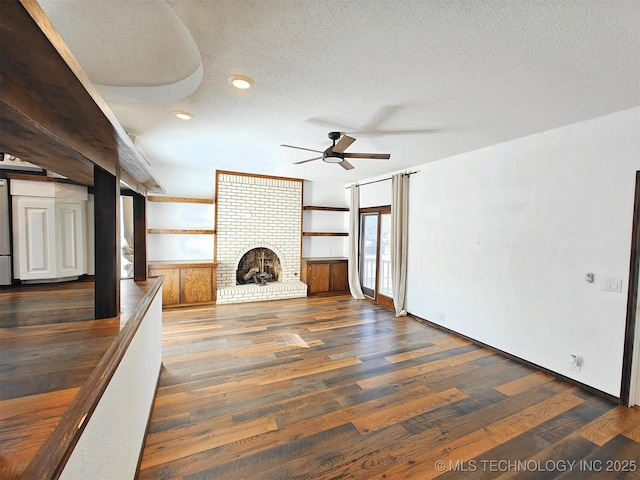 unfurnished living room with ceiling fan, recessed lighting, a fireplace, wood finished floors, and a textured ceiling