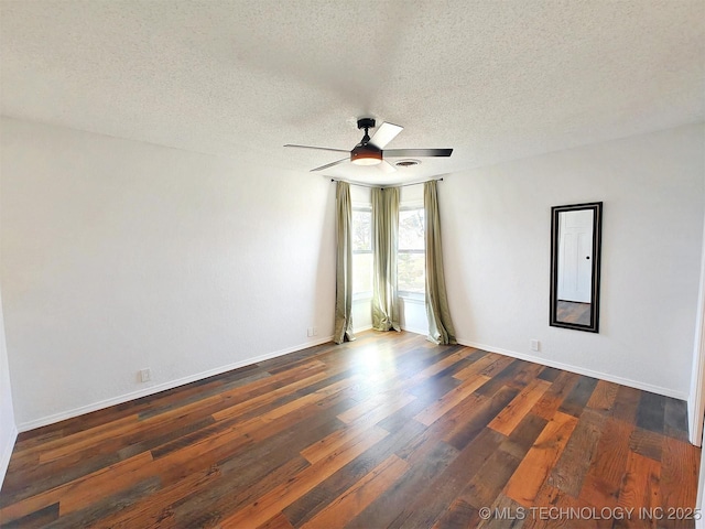 empty room featuring a textured ceiling, baseboards, a ceiling fan, and dark wood-style flooring