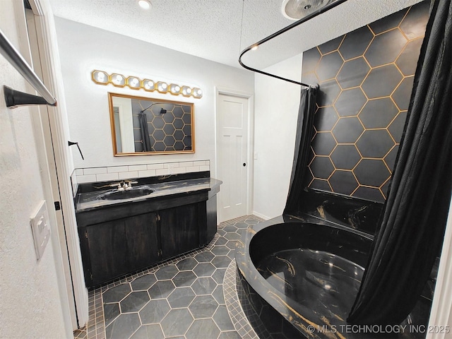 full bathroom featuring tile patterned flooring, vanity, a shower with curtain, a bath, and a textured ceiling