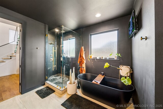 7701 S 21st St, Broken Arrow, OK 74011 - full bath with a soaking tub, baseboards, recessed lighting, and a stall shower
