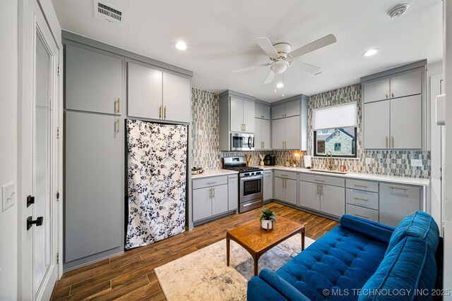 7701 S 21st St, Broken Arrow, OK 74011 - kitchen featuring visible vents, gray cabinets, appliances with stainless steel finishes, dark wood-style flooring, and a sink