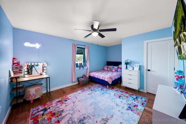 7701 S 21st St, Broken Arrow, OK 74011 - bedroom featuring baseboards, a ceiling fan, and wood finished floors