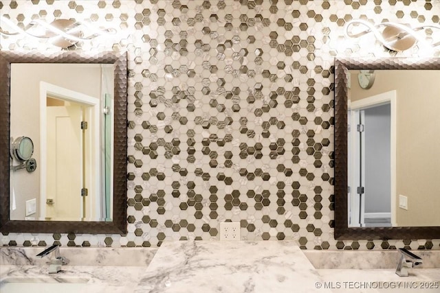 bathroom featuring tasteful backsplash and a sink