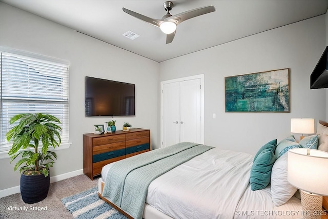 bedroom featuring baseboards, visible vents, ceiling fan, a closet, and carpet flooring