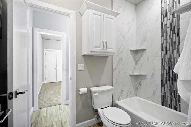 full bath with tub / shower combination, toilet, wood finished floors, and baseboards