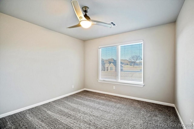 carpeted spare room featuring baseboards and a ceiling fan