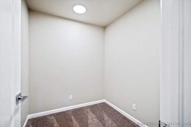 carpeted spare room featuring baseboards