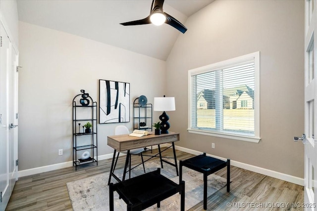 office area with light wood-style flooring, baseboards, lofted ceiling, and ceiling fan