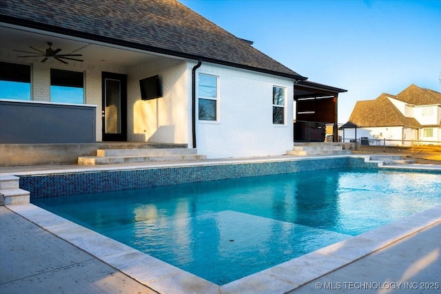 outdoor pool with a patio area and a ceiling fan