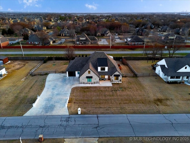 birds eye view of property with a residential view