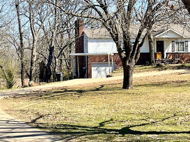 view of front of house with a front lawn, brick siding, and a chimney