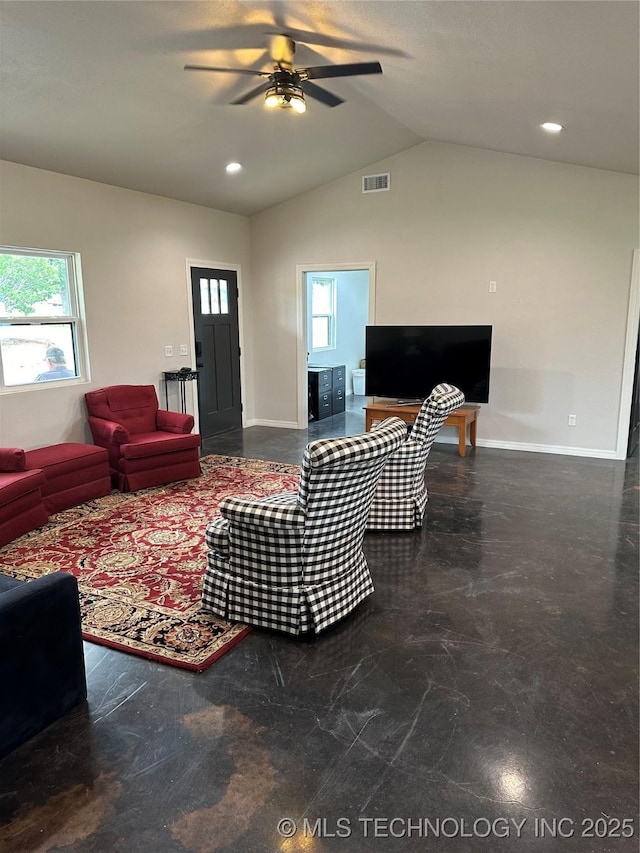 living room with lofted ceiling, a healthy amount of sunlight, visible vents, and baseboards