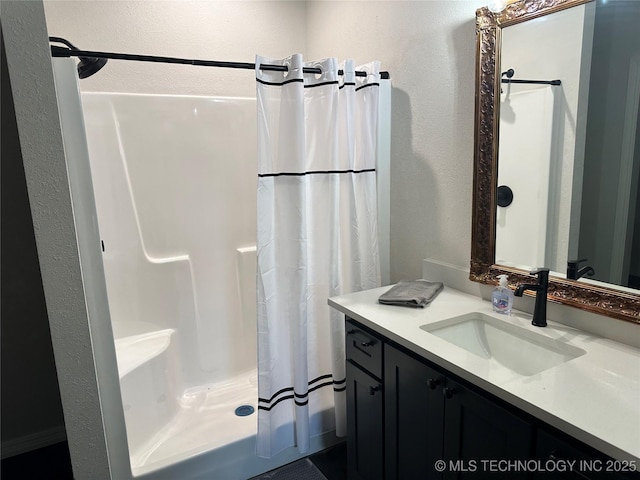 full bathroom featuring vanity and a shower with curtain