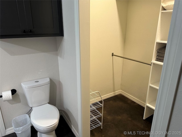 bathroom with baseboards and toilet