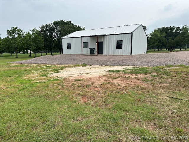 view of pole building with a lawn