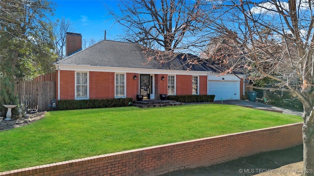 view of front of house featuring a front lawn, fence, a garage, brick siding, and a chimney