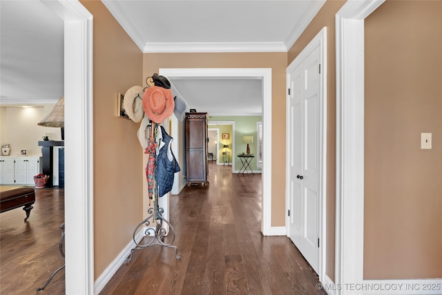 corridor featuring baseboards, dark wood-type flooring, and crown molding