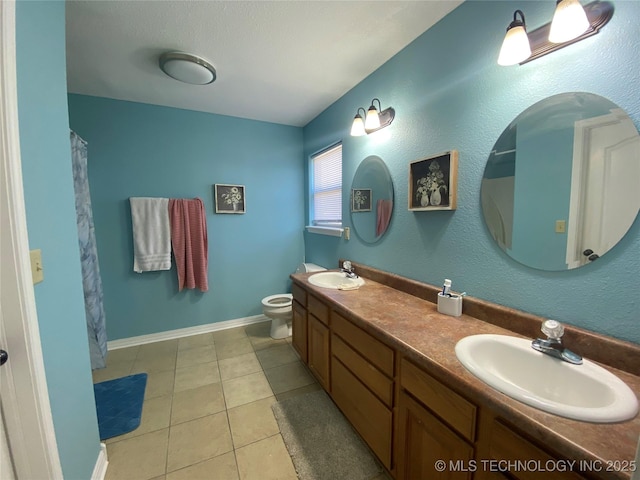 full bathroom featuring tile patterned flooring, double vanity, toilet, and a sink