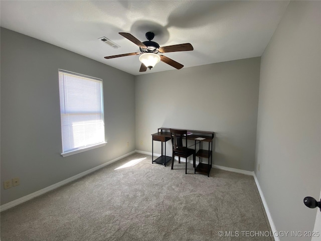 carpeted home office with baseboards, visible vents, and ceiling fan