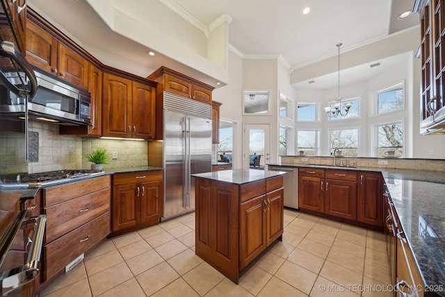 kitchen featuring a sink, light tile patterned flooring, backsplash, and stainless steel appliances