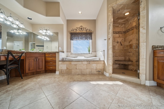 bathroom with tile patterned floors, a shower stall, a bath, and vanity