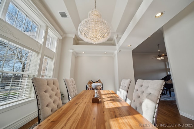 dining space featuring visible vents, ornamental molding, baseboards, and wood finished floors