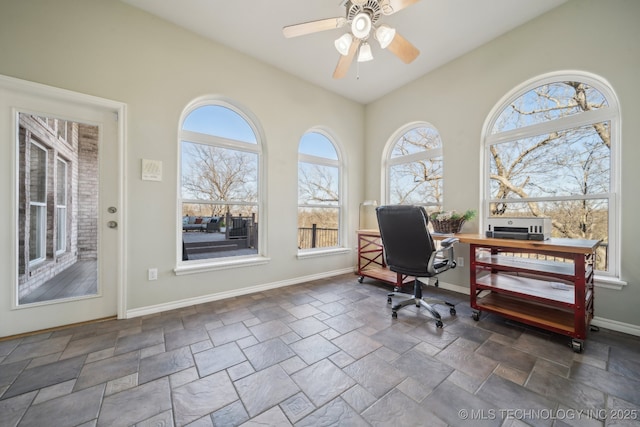 office featuring stone finish flooring, baseboards, and ceiling fan