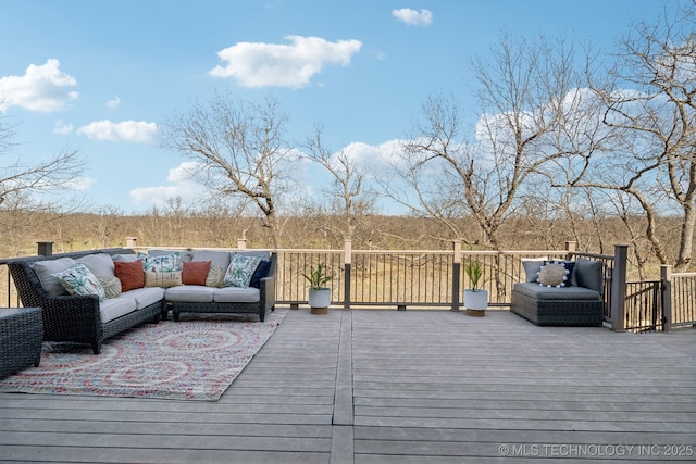 wooden terrace with an outdoor living space