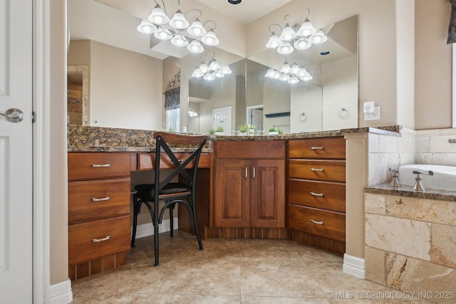 full bath with vanity, tile patterned floors, a notable chandelier, and a bathing tub