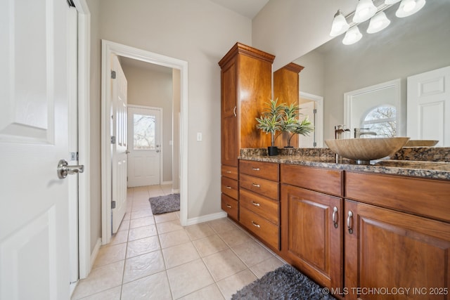 bathroom featuring vanity, tile patterned floors, and baseboards