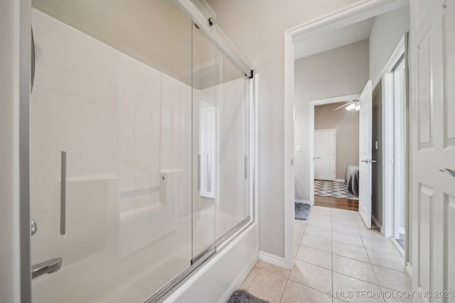 full bathroom featuring a ceiling fan, tile patterned floors, baseboards, and combined bath / shower with glass door