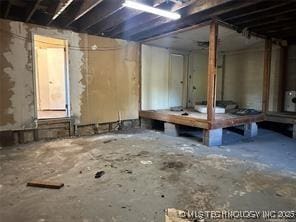 misc room with unfinished concrete floors