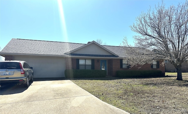 ranch-style house featuring brick siding, a front lawn, roof with shingles, driveway, and an attached garage