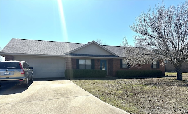 ranch-style house featuring brick siding, a front lawn, roof with shingles, driveway, and an attached garage