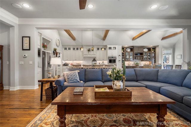 living room featuring wood finished floors, baseboards, recessed lighting, ornamental molding, and beamed ceiling