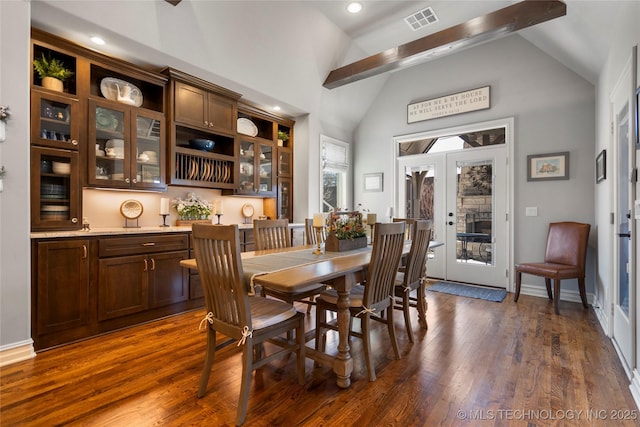 dining space featuring visible vents, french doors, dark wood-style flooring, and high vaulted ceiling